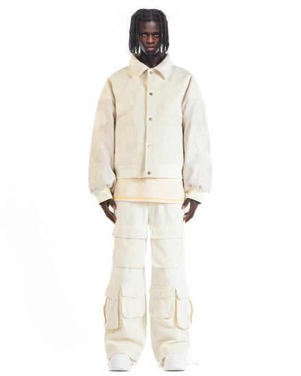 Untitled Artworks “Angel of Peace” varsity jacket in white with peace symbol embroidery and patches, oversized fit.