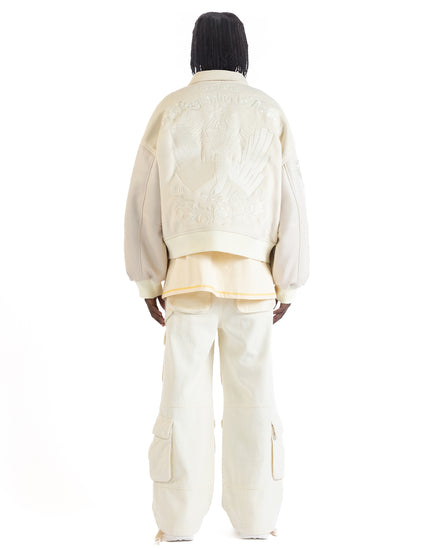 Untitled Artworks “Angel of Peace” varsity jacket in white with peace symbol embroidery and patches, oversized fit. back facing on model 