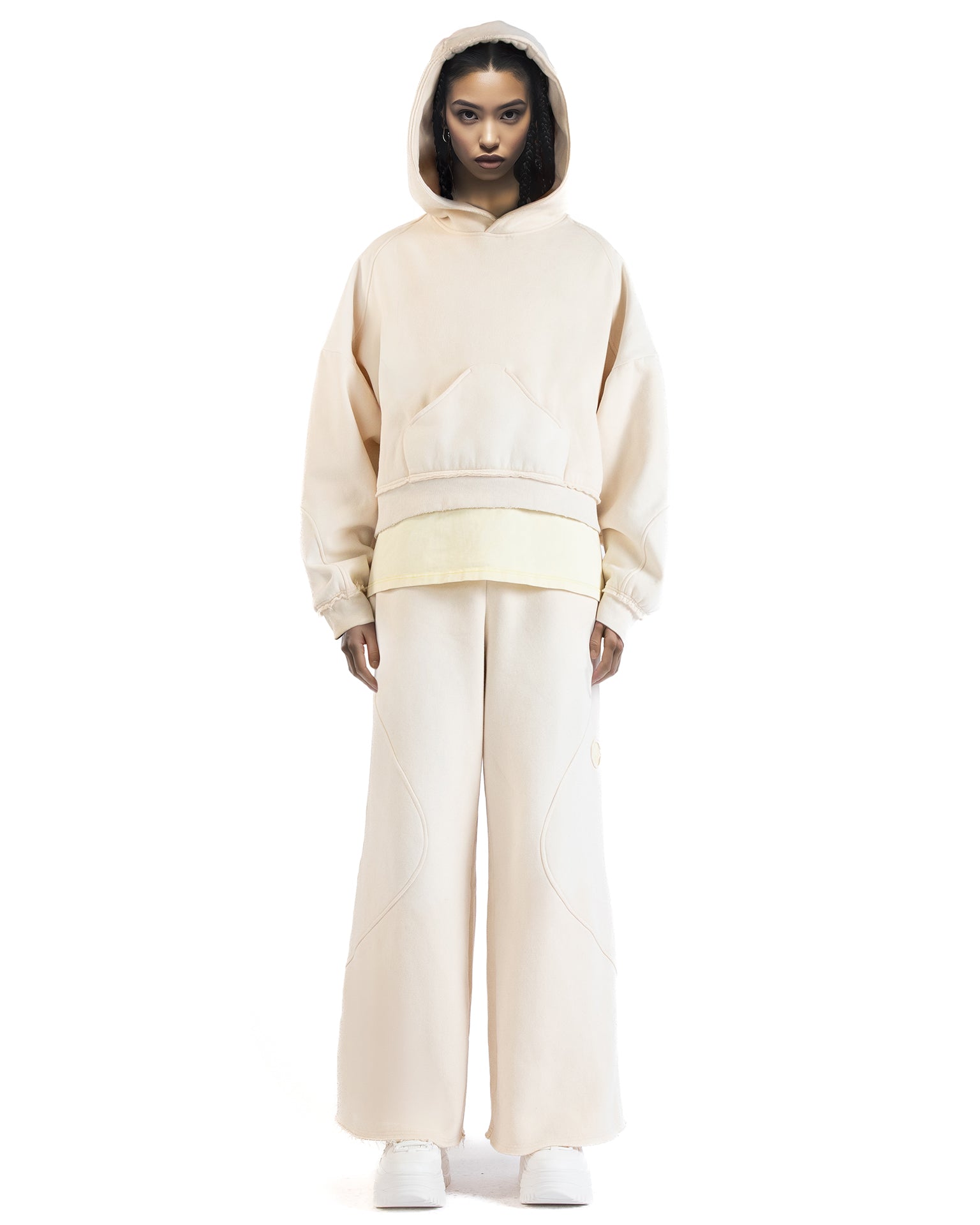 Front view of the Untitled Artworks Consumed Hoodie in cream, showcasing its oversized fit, kangaroo pocket, and unique stone wash effect.