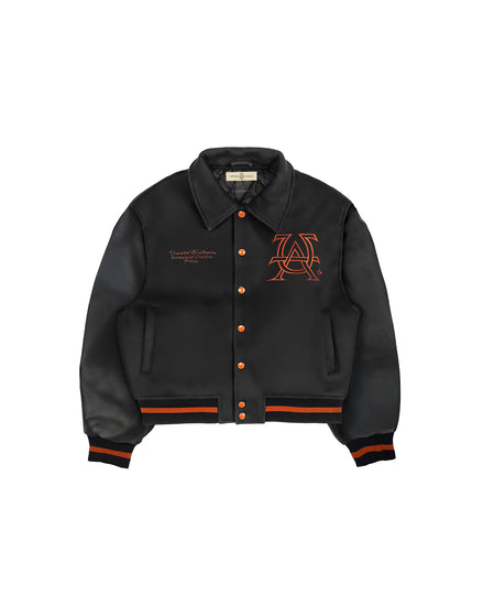 Untitled Artworks “Cult” varsity jacket in black with oversized fit and letterman-style embroidered graphics. flat front
