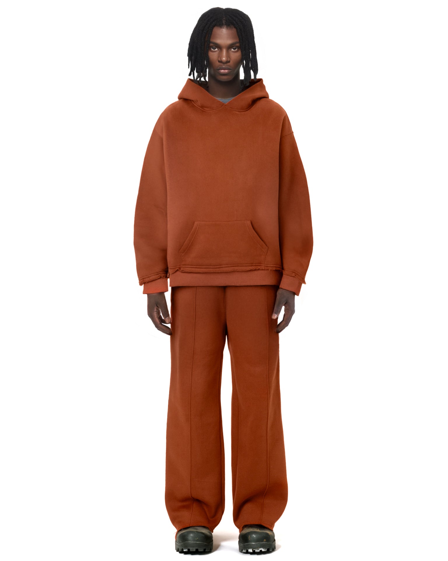 Untitled Artworks Essential Hoodie in Rust Brown – relaxed-fit fleece hoodie with raw-edge styling and front pocket. on model