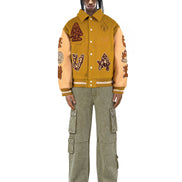 Untitled Artworks “Hunting Ginger” varsity jacket in ginger orange with hunting graphics and an oversized varsity silhouette. on model