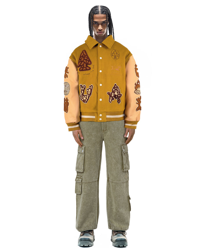 Untitled Artworks “Hunting Ginger” varsity jacket in ginger orange with hunting graphics and an oversized varsity silhouette. on model