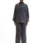 Front view of the blue corduroy shirt showing its button-front and boxy fit