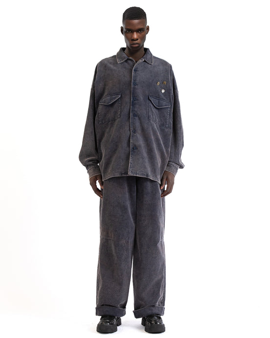 Front view of the blue corduroy shirt showing its button-front and boxy fit