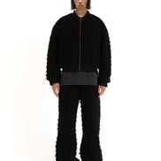 Front view of the blue patchwork denim jacket highlighting its boro-style repairs and oversized fit