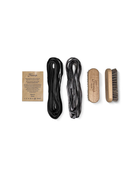 Close-up view of the Untitled Artworks x Fracap Destroyer Boot in black, accessories