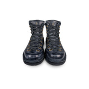 Close-up front view of the Untitled Artworks x Fracap Destroyer Boot in black, showcasing its spray-effect finish, oversized fold-over tongue, and antique brass eyelets.
