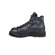 Close-up side 2 view of the Untitled Artworks x Fracap Destroyer Boot in black, showcasing its spray-effect finish, oversized fold-over tongue, and antique brass eyelets.