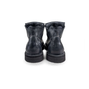 Close-up back view of the Untitled Artworks x Fracap Destroyer Boot in black, showcasing its spray-effect finish, oversized fold-over tongue, and antique brass eyelets.