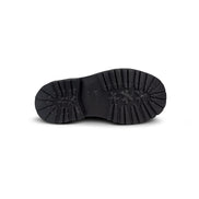 Close-up bottom view of the Untitled Artworks x Fracap Destroyer Boot in black, showcasing its spray-effect finish, oversized fold-over tongue, and antique brass eyelets.