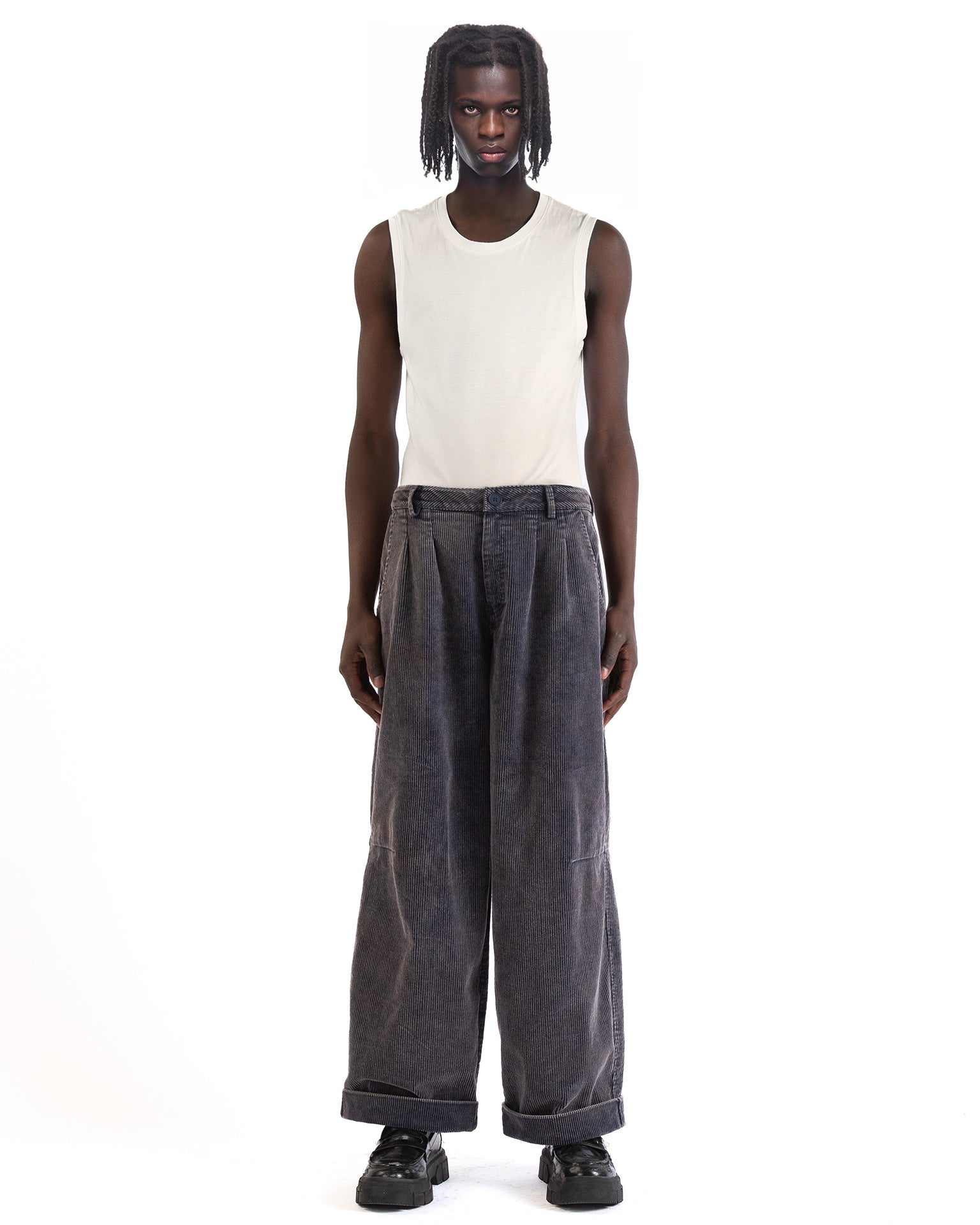 Front view of the blue corduroy pants showing the wide-leg cut and pleated front