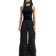 Front view of wide-leg washed black cargo pants showcasing the oversized fit and multiple pockets